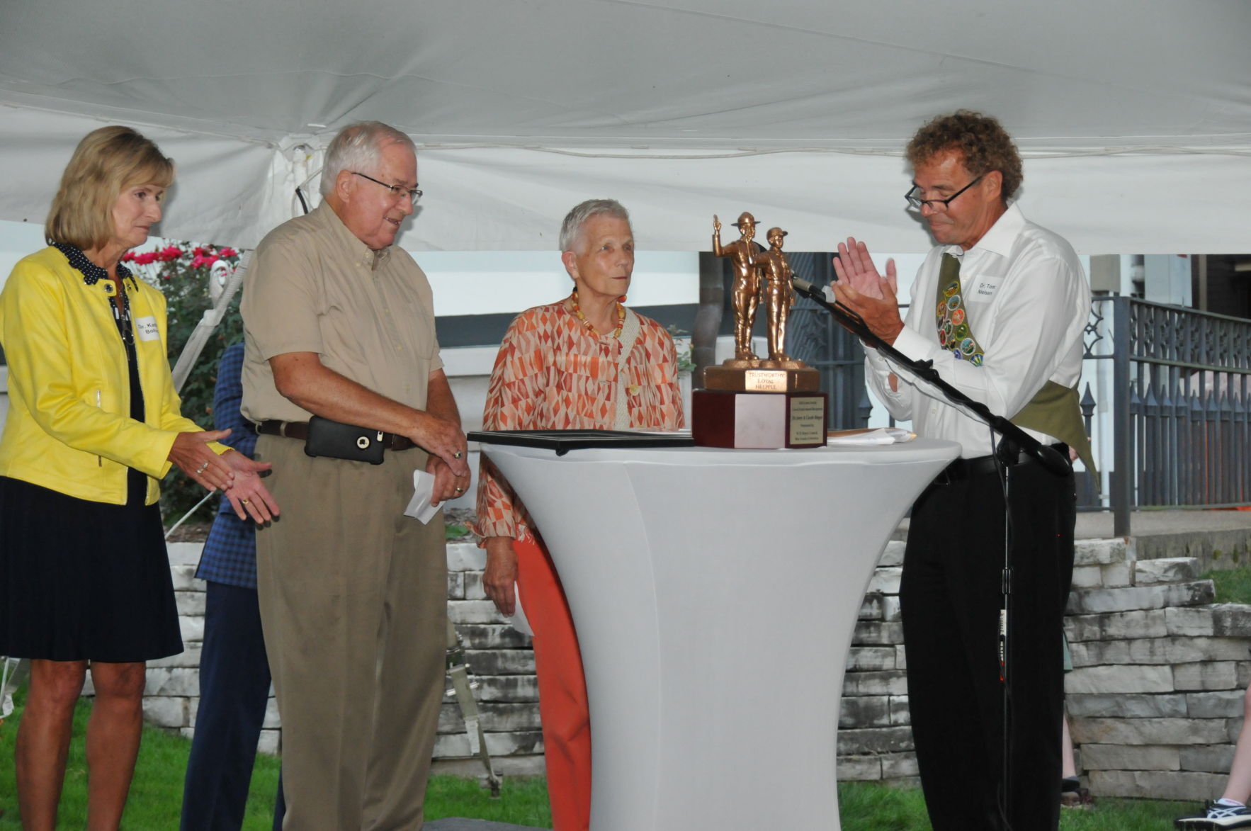 Drs. Kathy Bohn and Tom Nielsen applauding Good Scout honorees Jerry and Carole Ringer